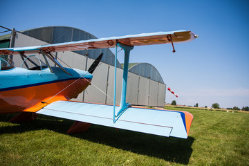 Light aircraft, modern biplane orange and blue