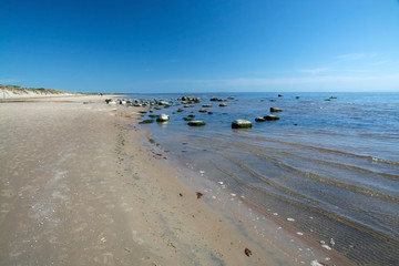 Sandy beach landscape with small rocks in Falkenberg, Sweden.