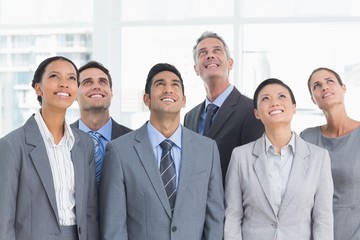 Business people looking up in office