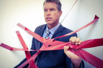 Businessman trapped by red tape