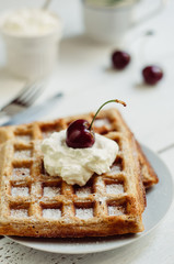 Breakfast with wholegrain waffles and whipped cream