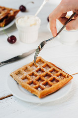 Breakfast with wholegrain waffles and whipped cream