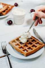 Breakfast with wholegrain waffles and whipped cream