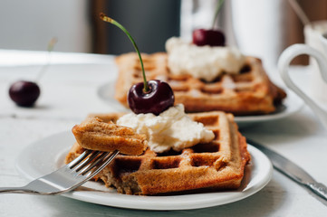 Breakfast with wholegrain waffles and whipped cream