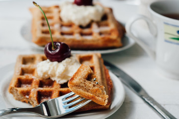 Breakfast with wholegrain waffles and whipped cream