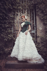 A woman like a princess in an vintage dress in fairy park