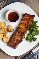 Barbecue pork  ribs on a white plate.