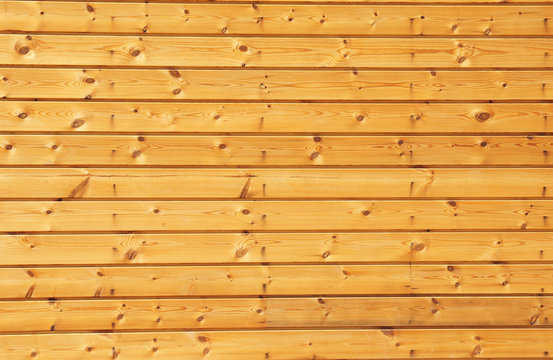 Background texture of finely slatted natural brown pine wood in a parallel pattern