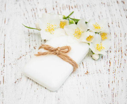 jasmin flowers and soap on wooden table