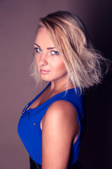 portrait of beautiful  curly young blond woman posing in studio