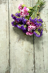 bunch of flowers on grunge wooden background