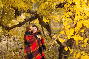 Happy young couple in love meeting on the autumn leaf