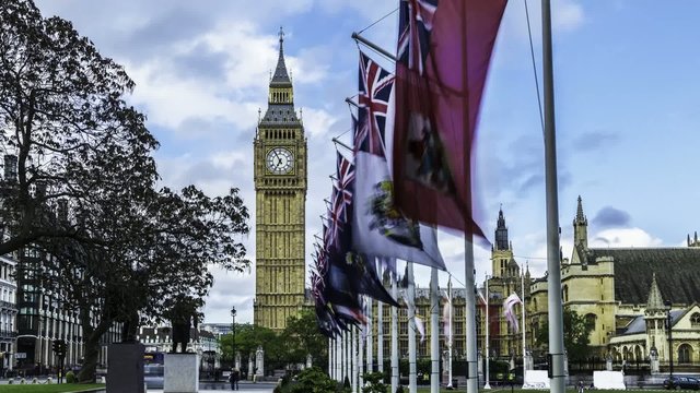 Timelapse view of the Big Ben and the House of Parliament , London. Seen throuugh flags of Commonwhealt nations flying in the wind