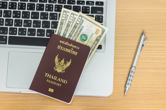 Thailand passport with laptop on table