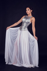 Pretty sexy girl full length posing in a fashion dress