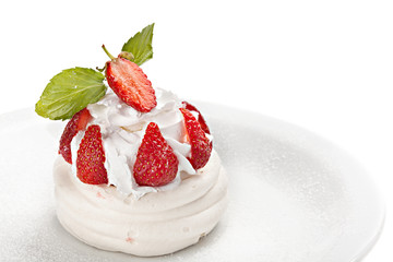 Meringue cake decorated with fresh strawberry and leaf of mint