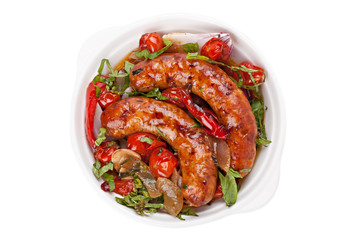 Sausages with stewed vegetables in bowl