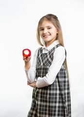 Isolated portrait of happy girl in school uniform holding apple