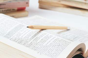 Open dictionary with  pencil