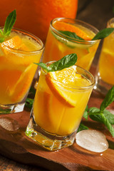 Refreshing cocktail with soda, orange, mint and ice, selective f
