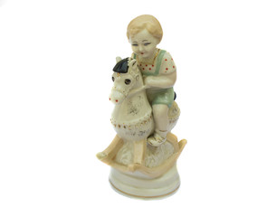 The boy on the horse, vintage porcelain figurine. Isolated on wh