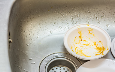 Kitchen conceptual image. Dirty sink with many dirty dishes.