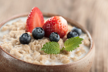Breakfast oatmeal with milk and berries