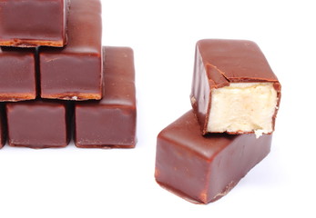 Stack of chocolate sweets on white background