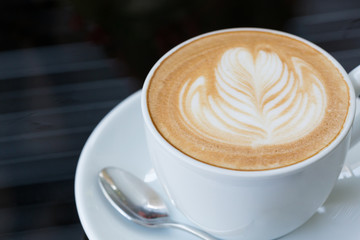 hot coffee latte, latte art with heart in a white cup