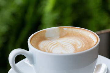 hot coffee latte, latte art with heart in a white cup