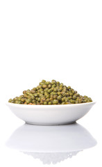 Mung beans in white bowl over white background