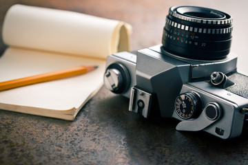 old analogue camera and notepad - Powered by Adobe
