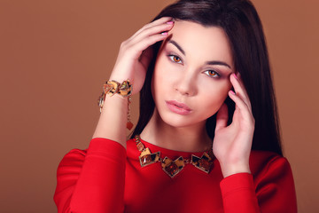 woman with dark hair and evening makeup. Jewelry and Beauty.