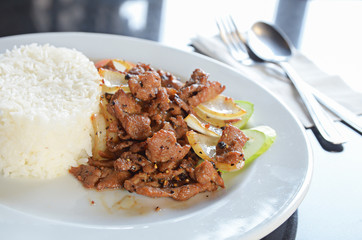 Rice with pork fried with black pepper on the table