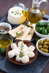 cheeses - mozzarella, feta cheese and pickles, vertical
