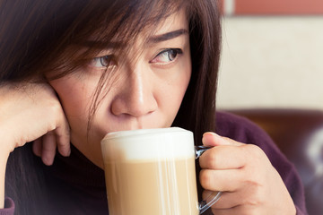 woman drinking a coffee latte in cafe
