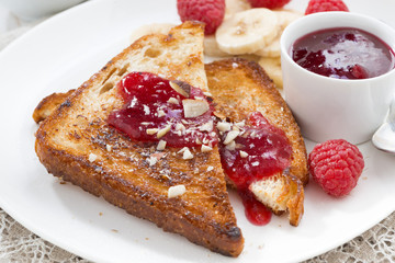 sweet breakfast - toasts with raspberries, banana and jam