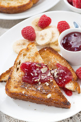 sweet breakfast - toasts with raspberries, banana and jam