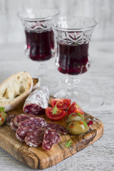 delicious appetizers for wine - Italian sausage, olives, tomatoes and ciabatta 