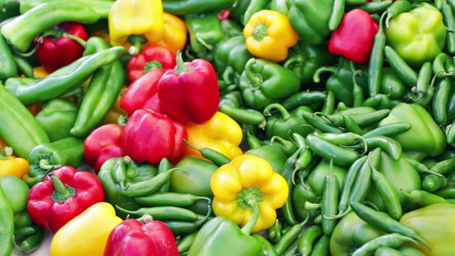 Variety of fresh organic peppers on the table at the local farmer's market.