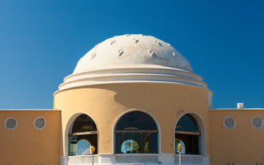 Greek style yellow building with white dome. Rhodes, Greece