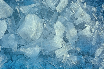 Fragmented and cracked ice at sunset as a background
