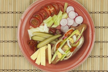 Domestic hot-dog with vegetables, fast food preparation at home.
