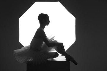 Ballerina sitting on a cube