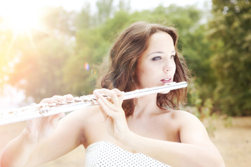 Music of the Summer - the Young Beautiful Woman Playing the Flute © AlexanderNovikov