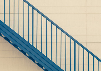 Metal stair and white wall at building exterior