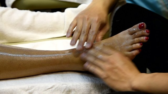 Foot massage in the spa salon, foot spa treatment.