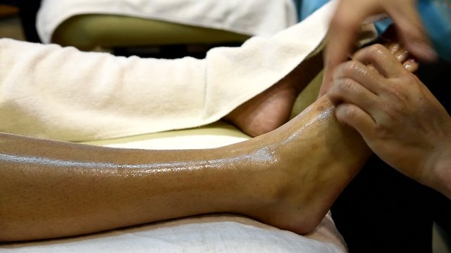 Foot massage in the spa salon, foot spa treatment.