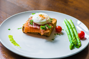 Sandwich with poached egg, parma ham and Salmon