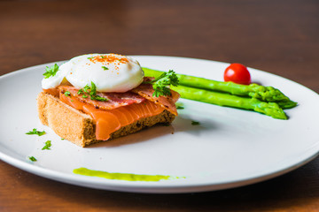 Sandwich with poached egg, parma ham and Salmon